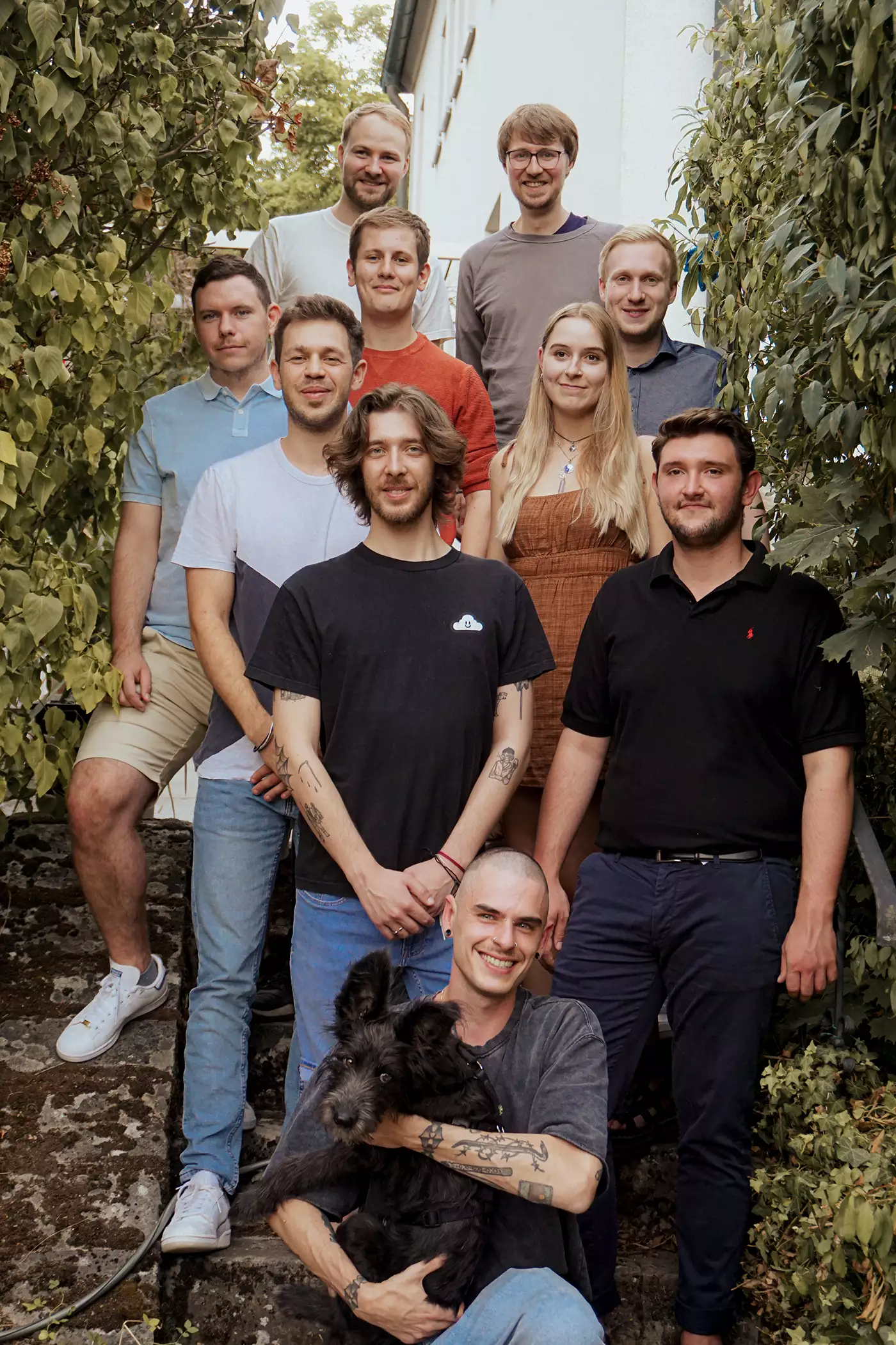 The Eye-Able team is standing on a staircase. You can see 10 people.