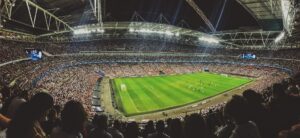 Shows a full soccer stadium under floodlights