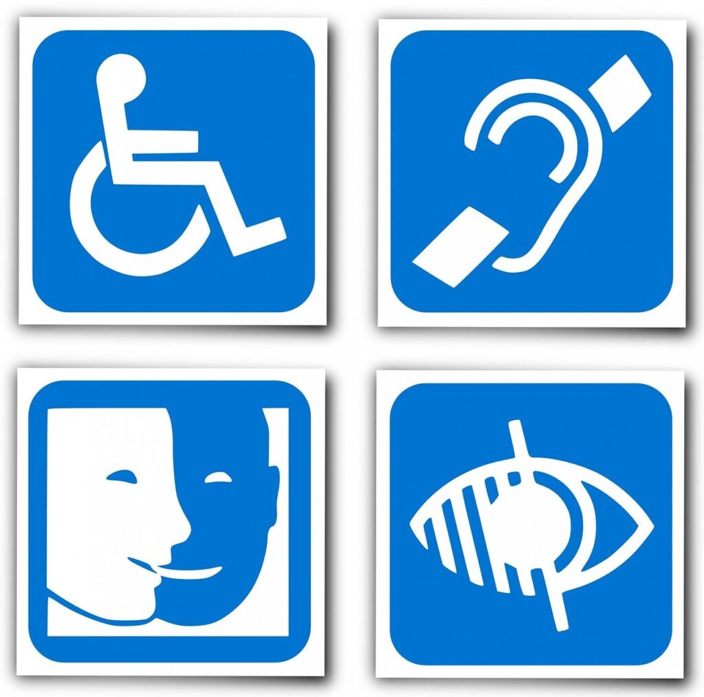 Four characters: A person in a wheelchair, a crossed-out ear, a dark and a blue face, a crossed-out eye